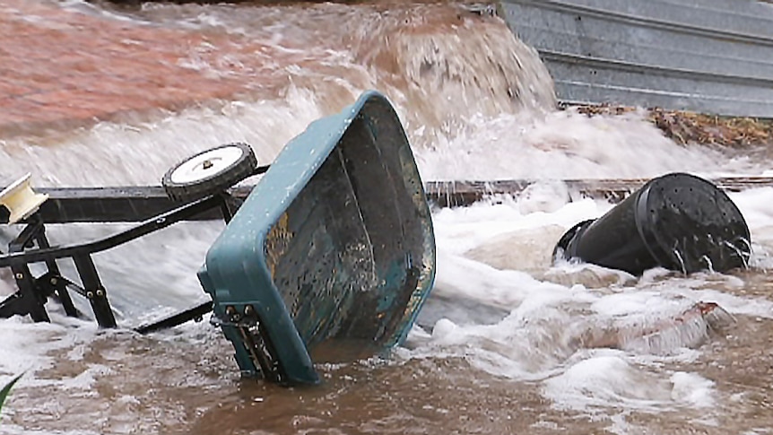 Water gushes through a backyard