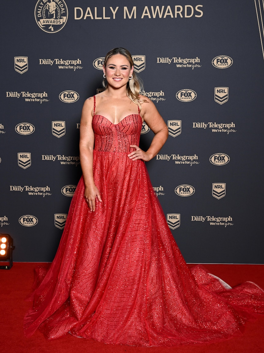 Keeley poses in a beaded red dress on the red carpet. 