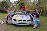 Kyogle CWA members surround a vehicle decorated in fabric, paper, ribbon and lace.