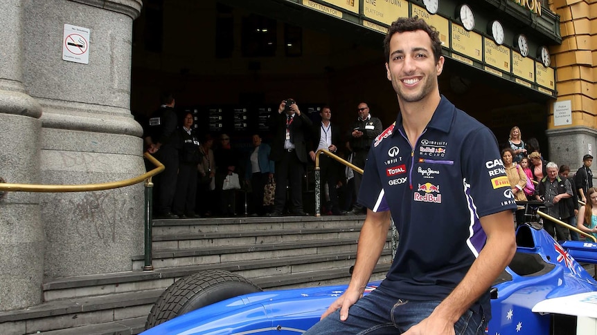 Daniel Ricciardo of Australia and Infiniti Red Bull Racing poses on a Formula 1 car at the steps of Flinders Street Station during the 2015 Formula 1 Australian Grand Prix Launch
