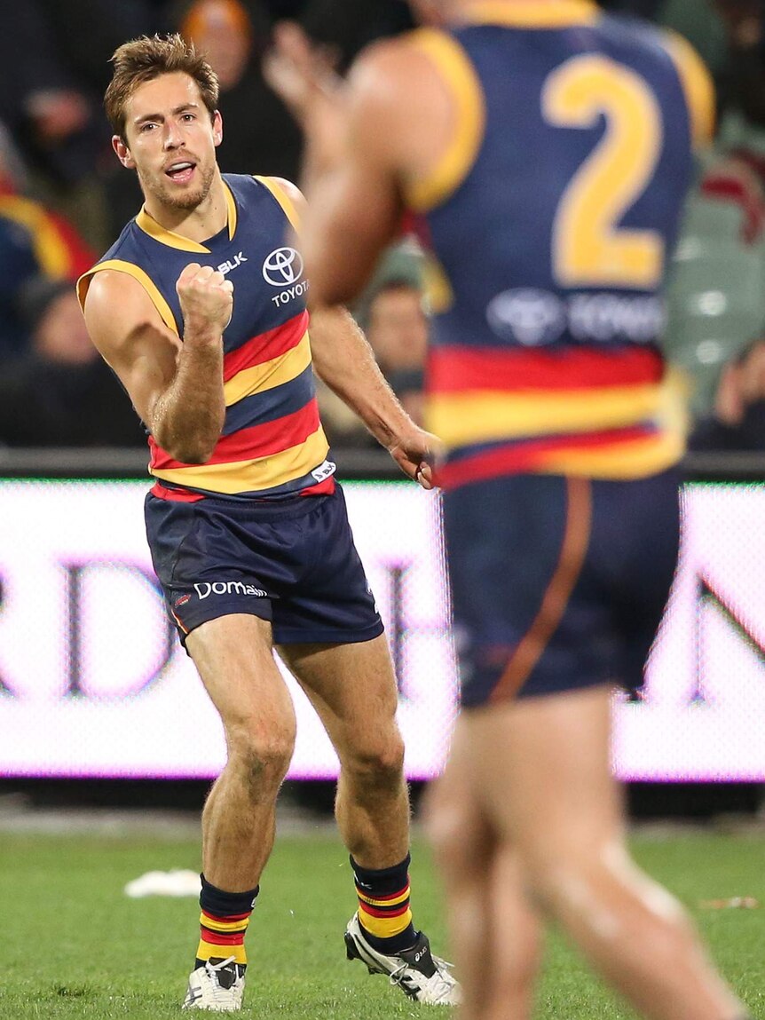 Richard Douglas of the Crows reacts after kicking a goal