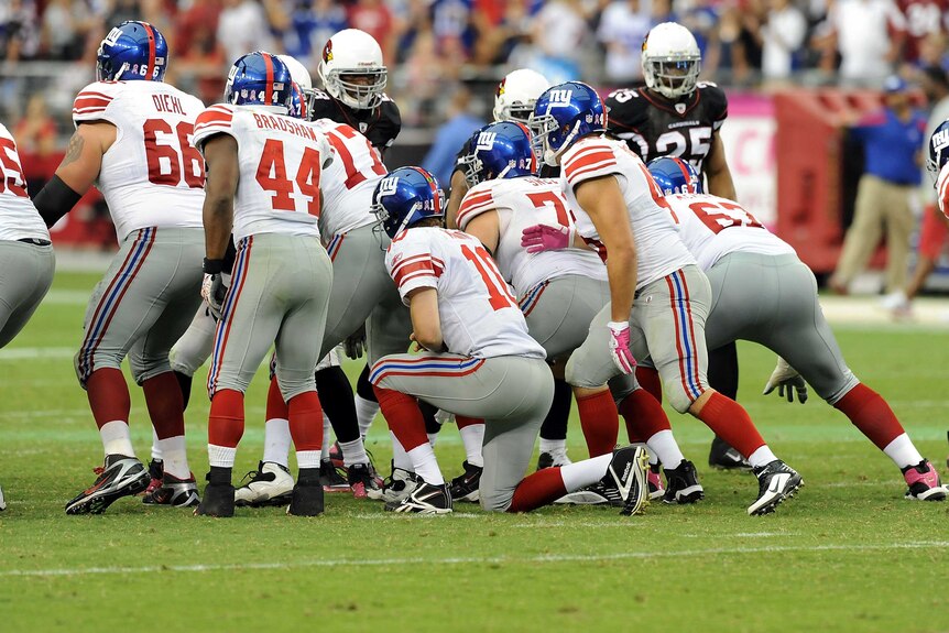 Eli Manning #10 of the New York Giants takes a knee to run out the clock against Arizona Cardinals.