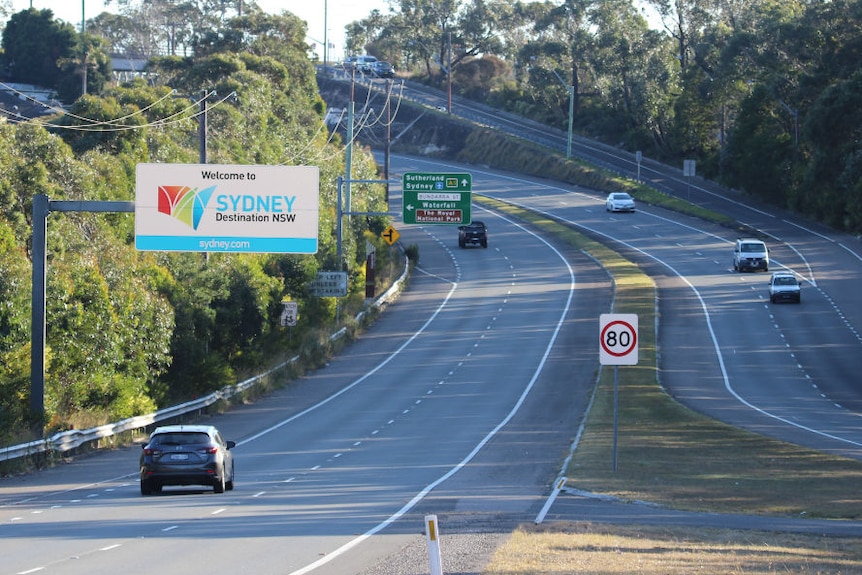 Freeway heading into Sydney from the south with only a few cars on either side of the carriageway