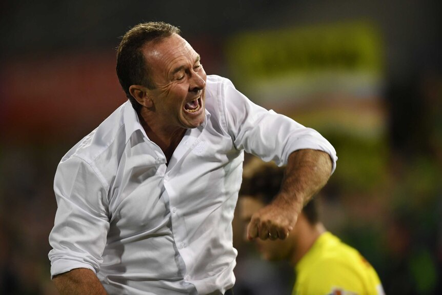 Canberra Raiders coach Ricky Stuart punches the air