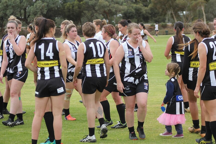 Women's AFL players take to the field in country Victoria.