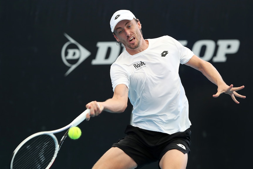 An Australian male professional tennis player hits a forehand.