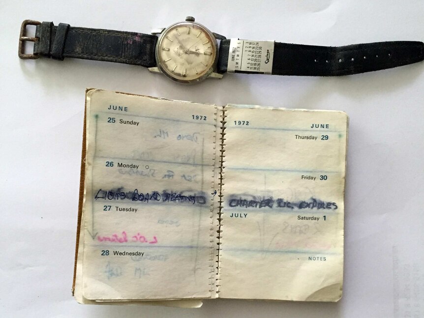 A watch and diary, water damaged.