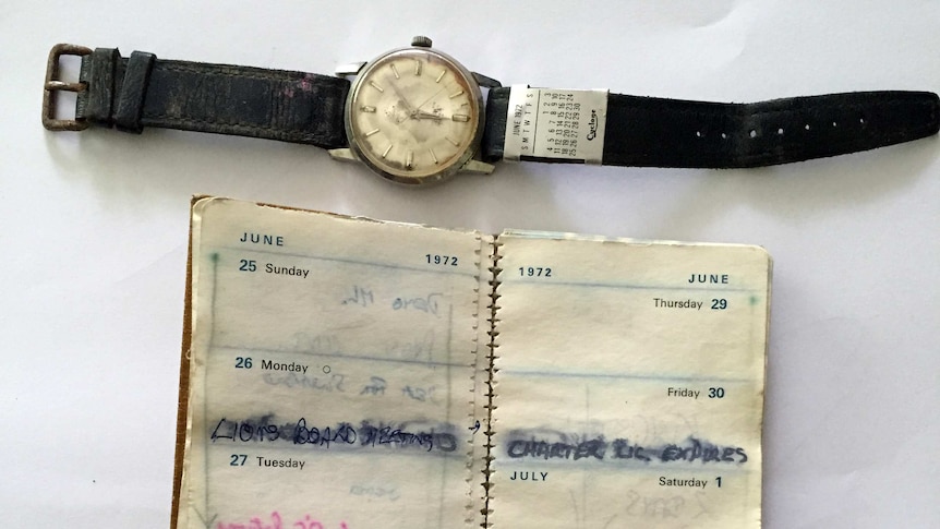 A watch and diary, water damaged.