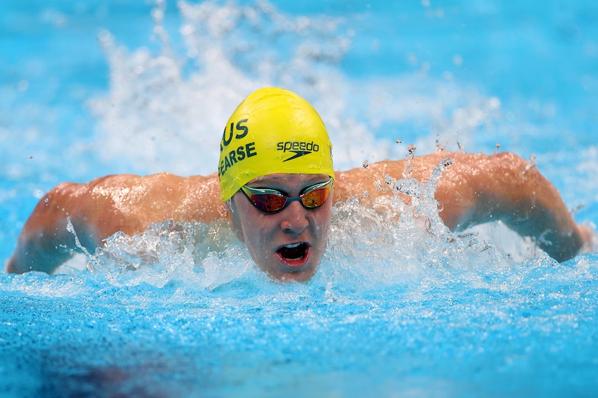 A man in a bright swimming cap competes in a race.