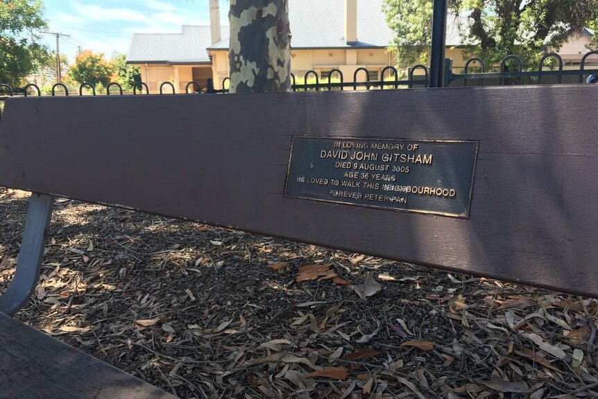 David John Gitsham plaque on a seat outdoors.