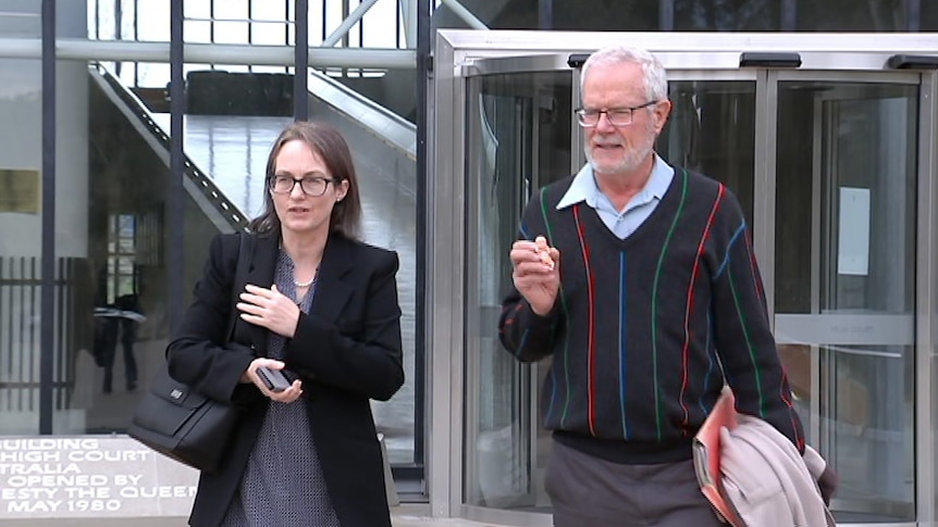 Kathleen Clubb walks alongside Graham Preston, who holds a model foetus.