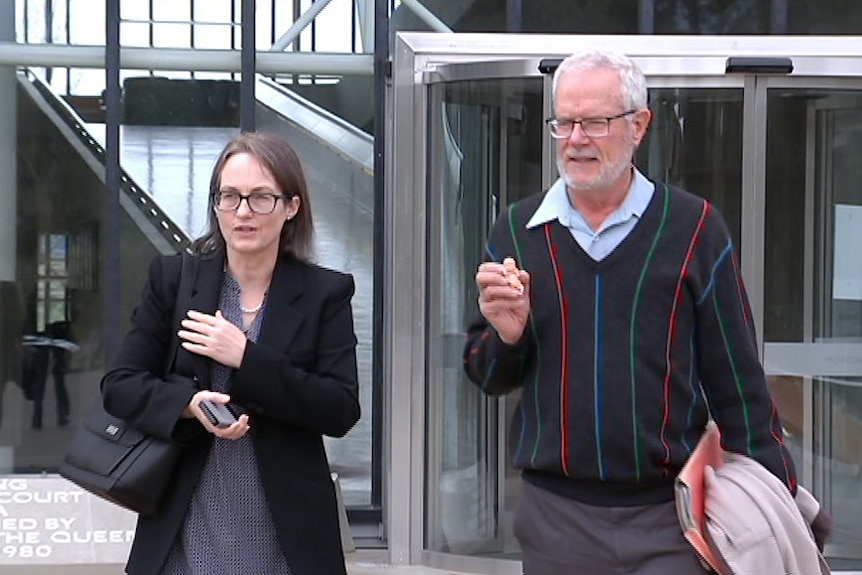 Kathleen Clubb walks alongside Graham Preston, who holds a model foetus.