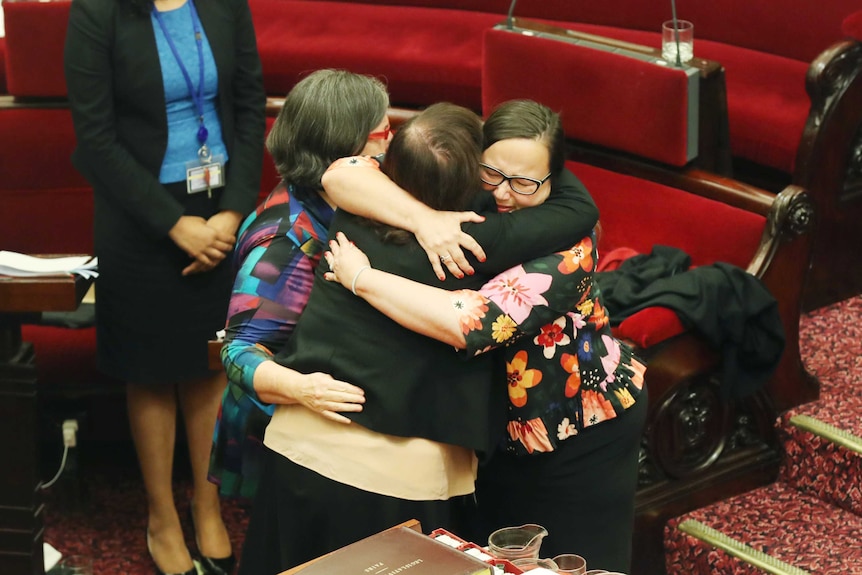 Victorian Greens MP Colleen Hartland (left) embraces a fellow MP after the Voluntary Assisted Dying Bill passes the Upper House.
