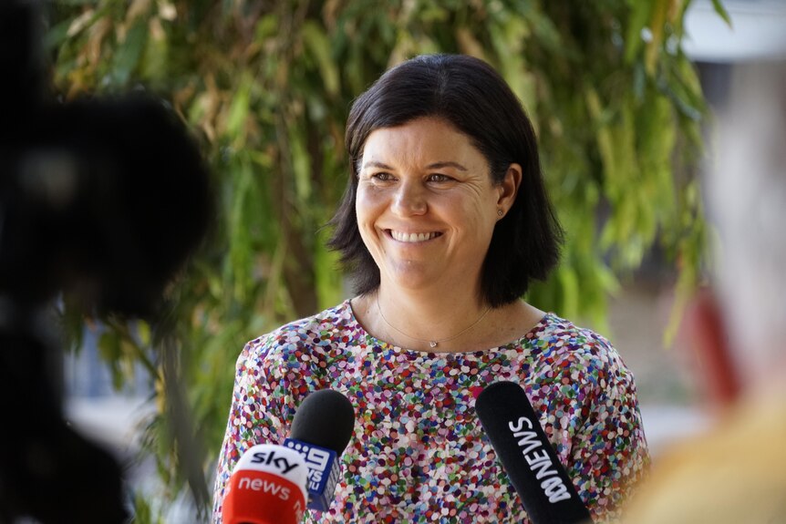 NT Health Minister Natasha Fyles smiles at a press conference.
