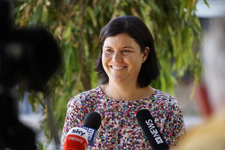 NT Health Minister Natasha Fyles smiles at a press conference.