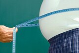 A tape measure around a man's waist