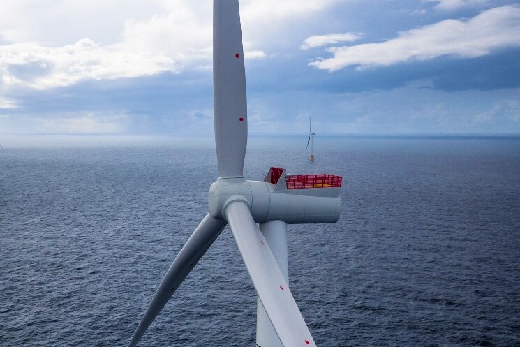 Aerial view of a giant wind turbine installed at sea