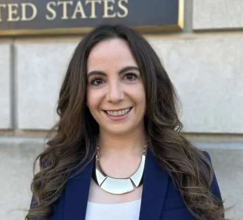 A woman looks at the camera smiling