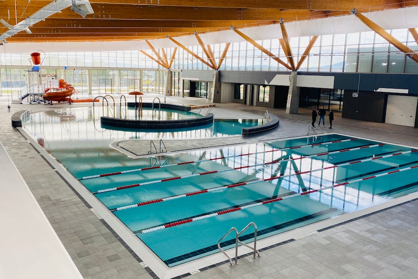 A large indoor pool with grandstand seating.