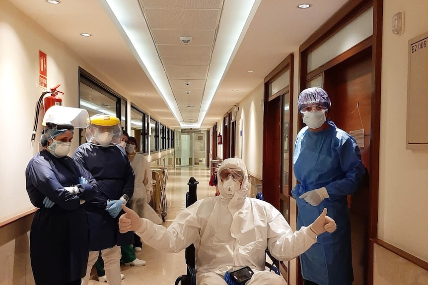 Medical staff surround Jesz in a hospital corridor.