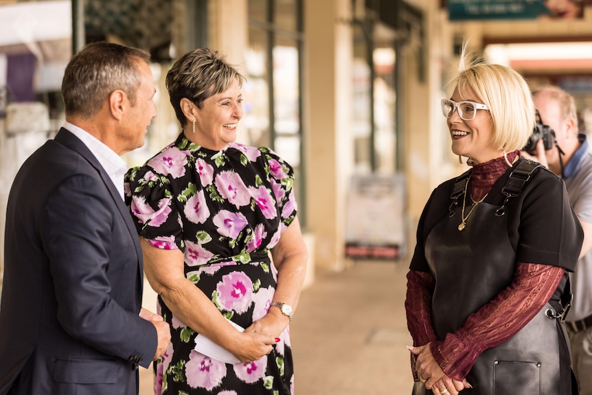 Two women speaking on a CBD footpath with a man who is WA Premier Roger Cook.  