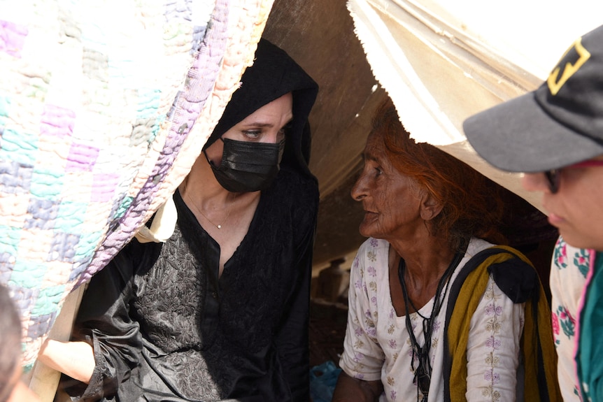 a picture of two women talking 