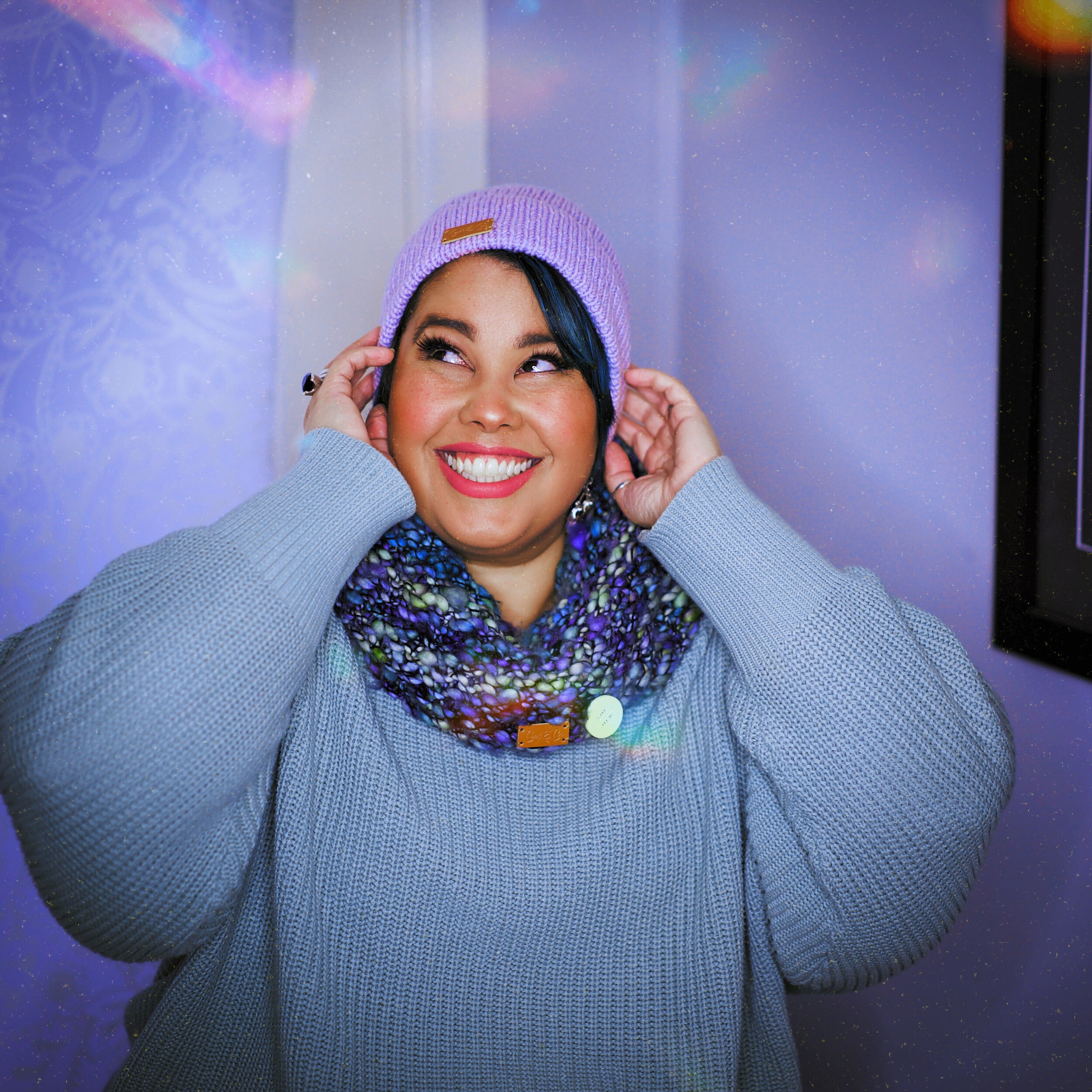 April Helen-Horton aka The Bodzilla wears a purple beanie and blue jumper