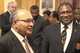 PNG Prime Minister Peter O'Neill stands to the right of Electoral Commissioner Patilias Gamato