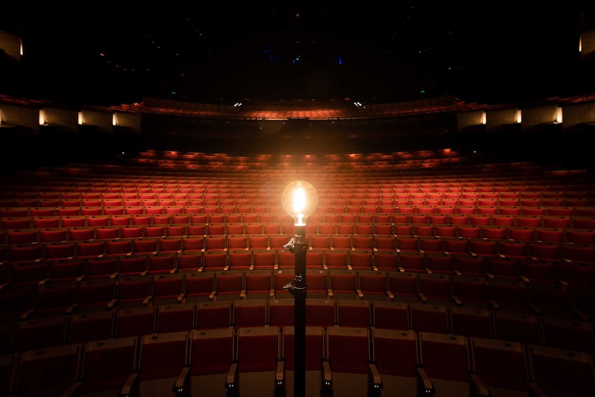 A lone lit globe in the empty auditorium at the The Sydney Opera House