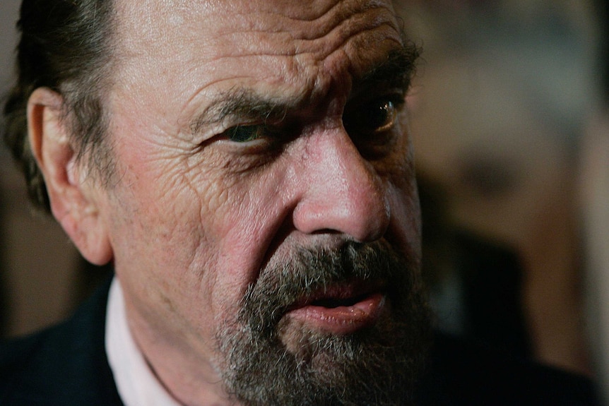 Rip Torn stares into the camera with a quizzical expression