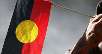 Man holding Aboriginal flag