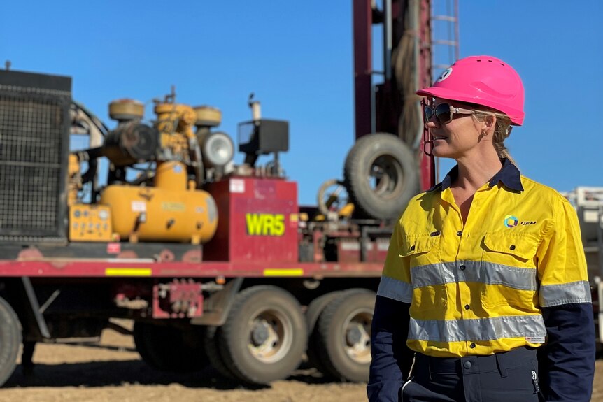 Mining media boss Joanne Bergamin in safety gear in front of mining equipment