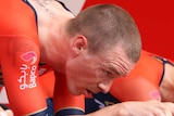 Rohan Dennis strains and looks forward as he pedals on an exercise bike