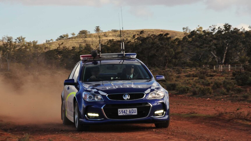 SA Police car on a dirt road.