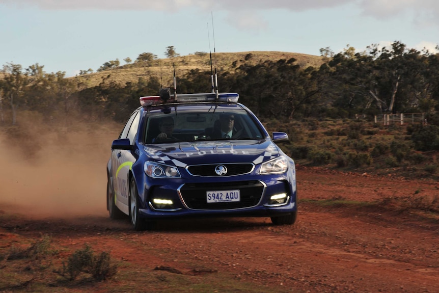 SA Police car on a dirt road.