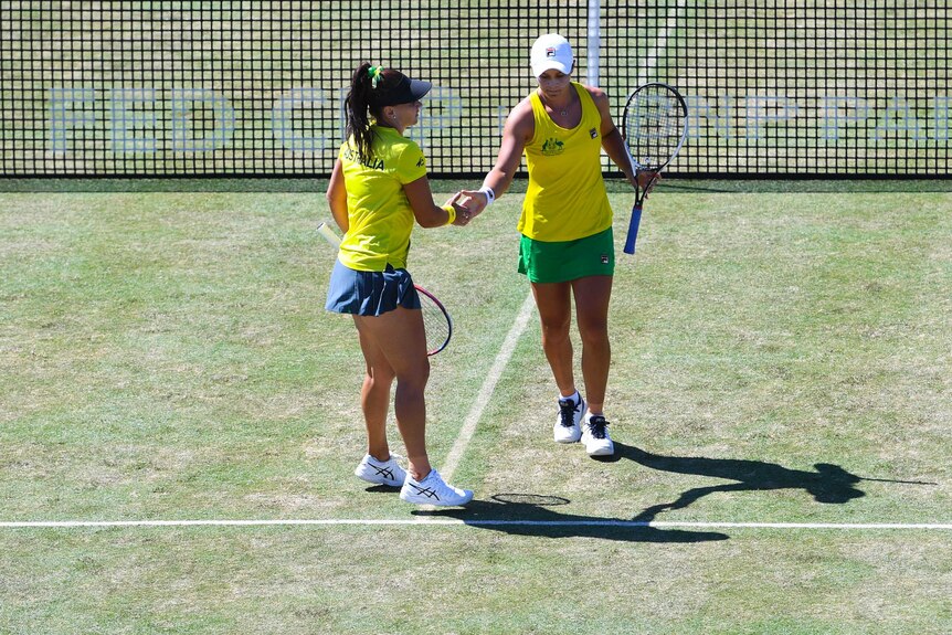 Australia's Casey Dellacqua and Ash Barty react during their Fed Cup doubles against Ukraine