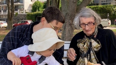 Wendy Smith wearing glasses and a scarf with her daughter and grandson