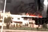 A building burns in the Syrian city of Homs, which is the subject of continuing assault.
