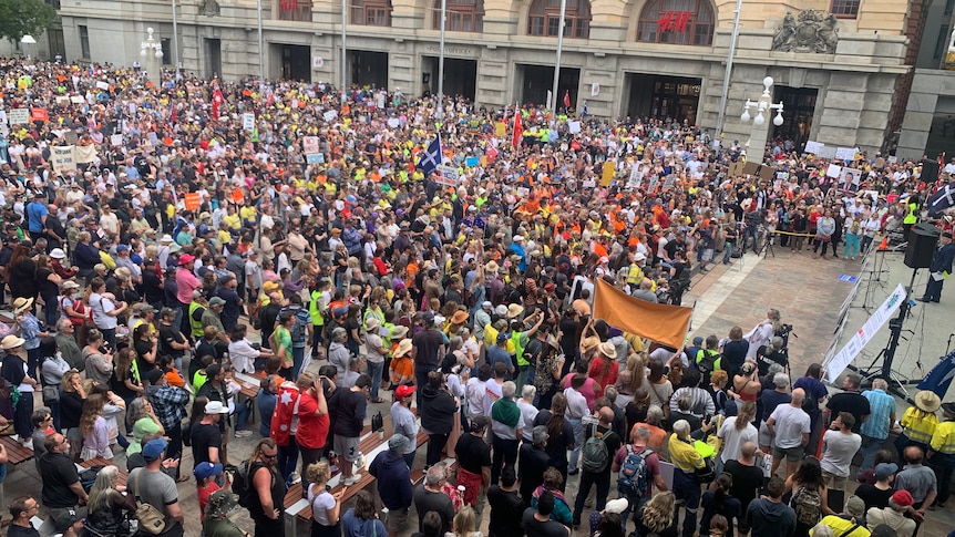 A crowd of people in Forrest Place with flags and banners protesting COVID-19 restrictions.