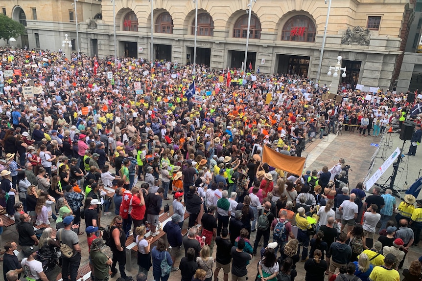 A crowd of people in Forrest Place with flags and banners protesting COVID-19 restrictions.