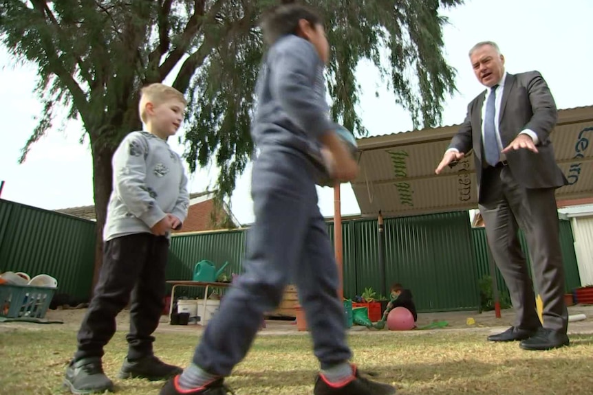 A man gesticulates at two children