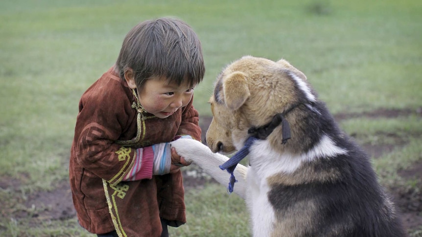 Boy from Mongolia with pet dog