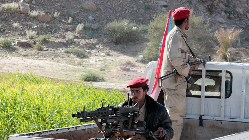 Men on a truck with guns.