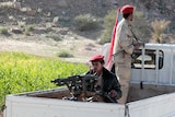 Men on a truck with guns.