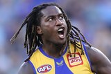 West Coast Eagles AFL player Nic Naitanui shouts as he runs after kicking a goal against Fremantle Dockers.