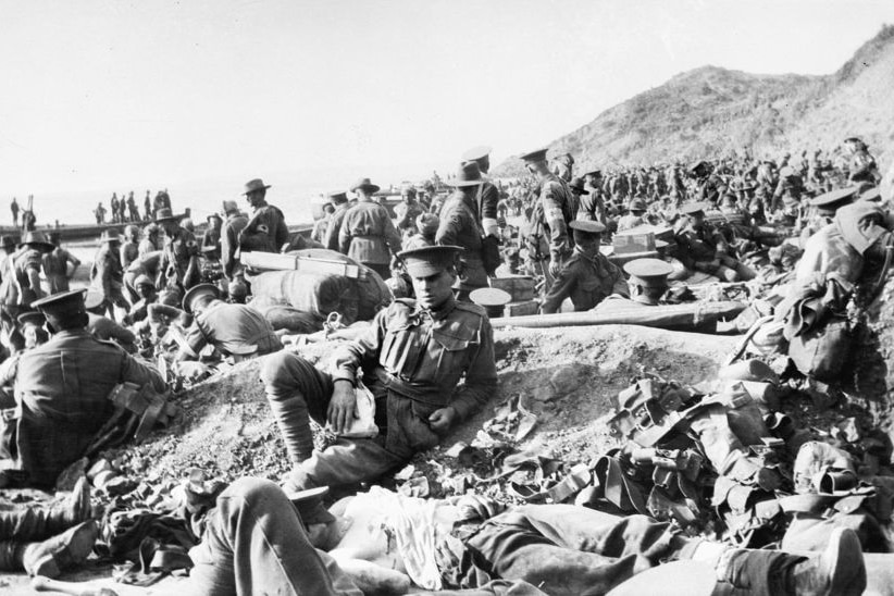 Hundreds of soldiers move among the dead and wounded on the beach at Anzac Cove, April 25, 1915