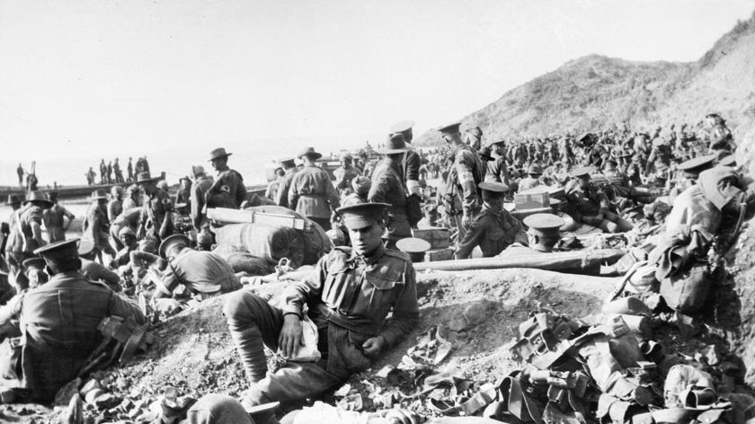 Hundreds of soldiers move among the dead and wounded on the beach at Anzac Cove, April 25, 1915