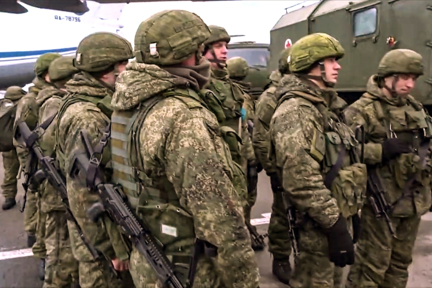 Russian troops wait to leave an airport in Almaty after arriving to help quell the protests, January 9, 2022.