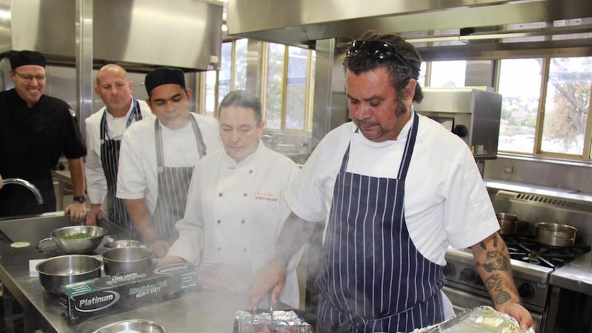 A chef working with students