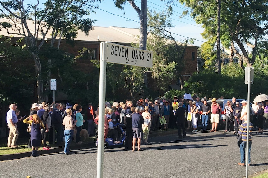 A group of about 50 protesters on a suburban street